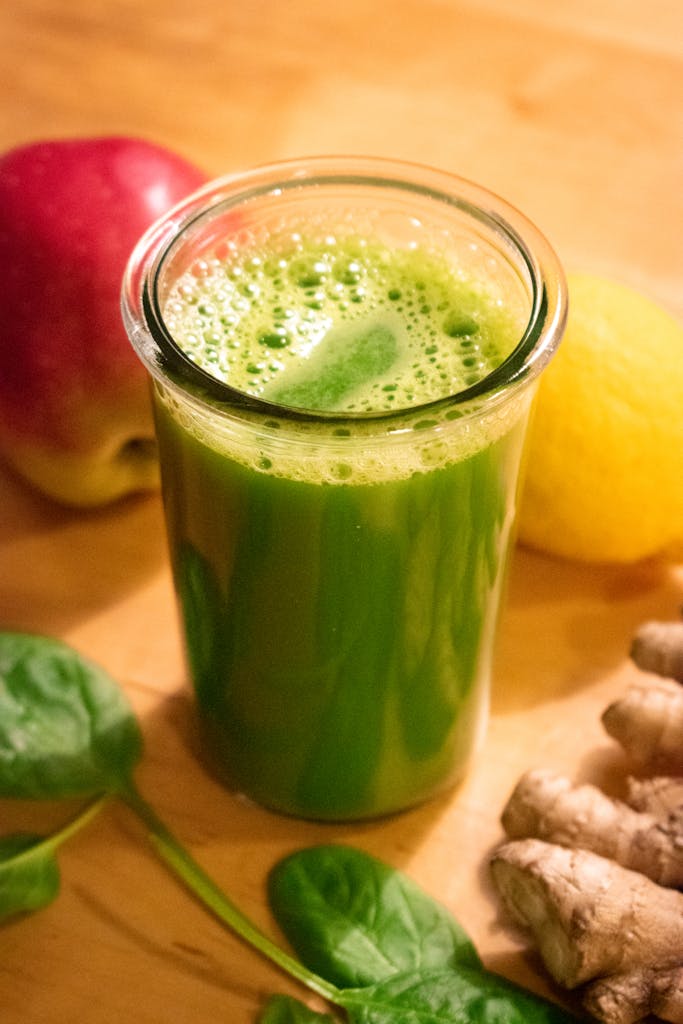 Fresh vegetables with juicer and juice glass.