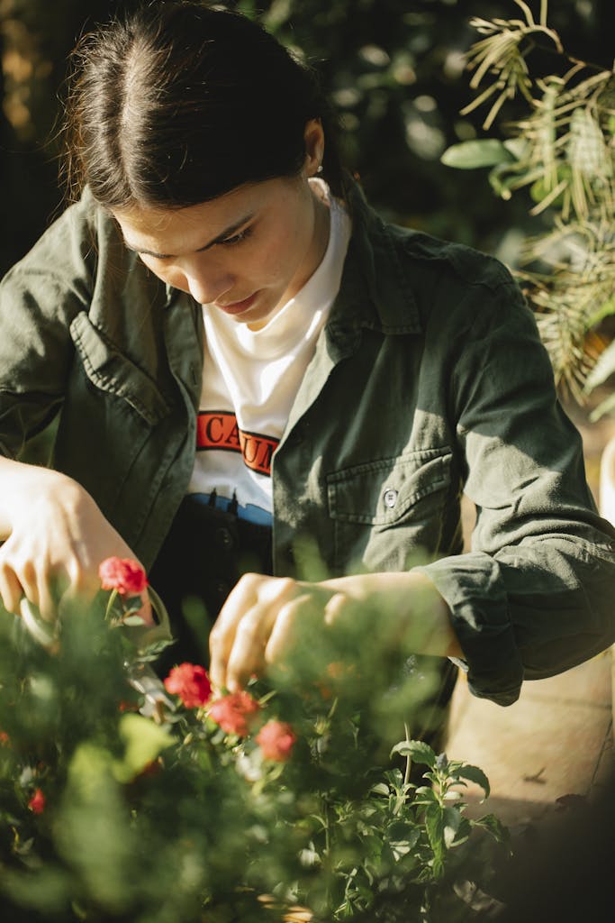 Gardener planting carrots in sunny Florida garden.