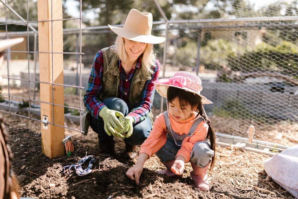 Planting orange carrot seeds in sandy Florida garden.