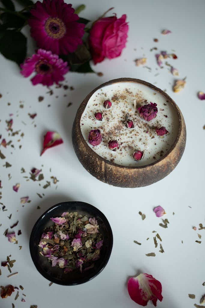 A bowl of milk and flowers next to a bowl of flowers